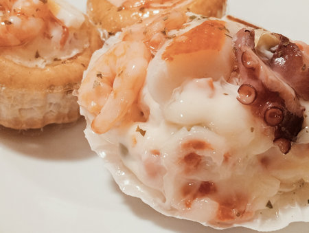 Seafood appetizer on a white plate, close-up