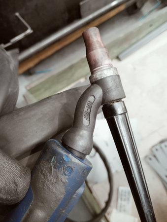 Welding work with a welding torch in a workshop, closeup of photoの写真素材