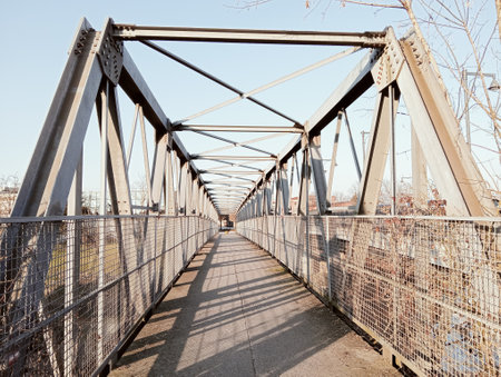 metal bridge over the river in the city on a sunny spring day