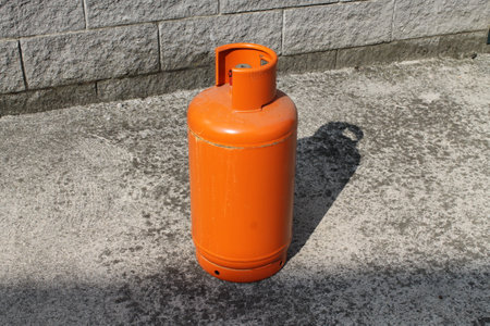Orange gas cylinder on the street, closeup of photo.の写真素材