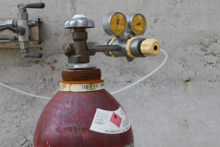 Fire extinguisher in the construction site, closeup of photo.の写真素材