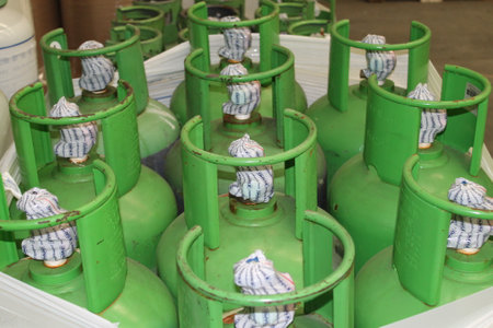 Green gas cylinder in factory, closeup of photo with soft focus