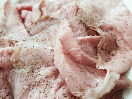 Slices of pork on a white plate. Close-up.の写真素材