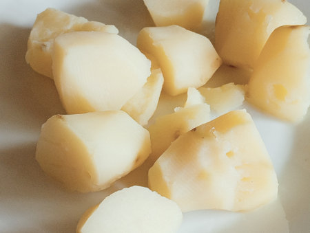 Pieces of raw potatoes on a white plate. Toned.の写真素材