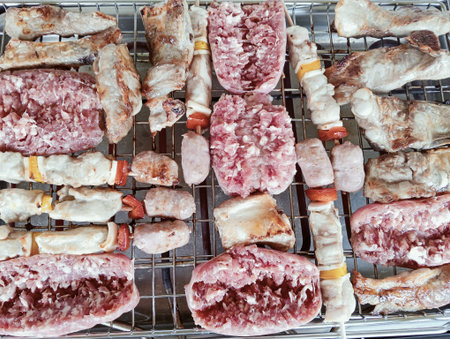 Skewers of pork and beef on a barbecue grill.の写真素材
