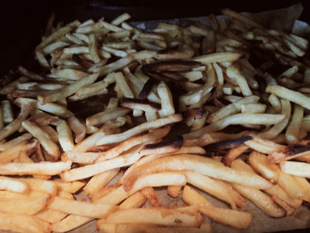 French fries on a wooden table. Selective focus. Toned.の写真素材