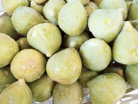 Green figs in plastic bag for sale at street food market.