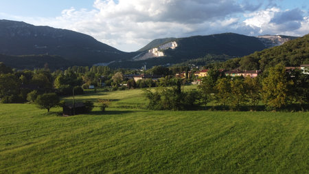Panoramic view of a green meadow and mountains in the background