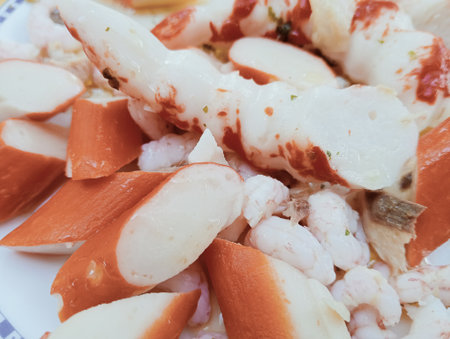 closeup of a plate of shrimps and crab sticks in a restaurantの写真素材