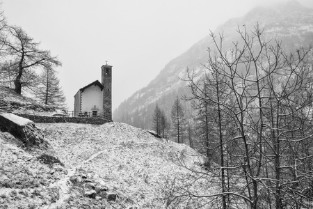 Little church in a winter mountain landscape covered with fresh snowの写真素材