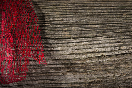 Red ribbon over wooden backgroundの写真素材