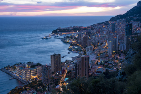 Panoramic view of Monte Carlo in the evening. The Principality of Monaco is situated on a prominent escarpment at the base of the Maritime Alps along the French Riviera.の写真素材