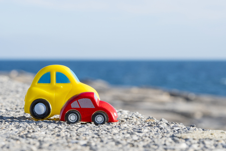 Toy Car near the sea. Travel, tourism, holiday and adventure concept.の写真素材