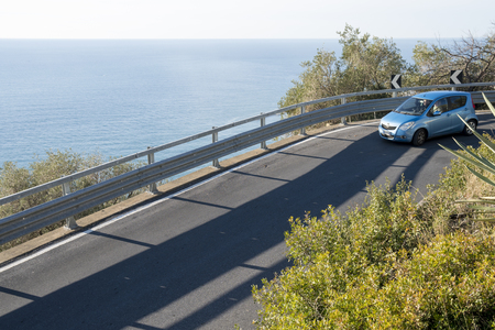 Car on a country road near the seaの写真素材