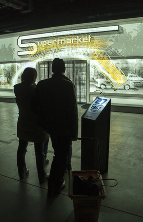 Milan, Italy - January 07, 2018: visitors to the exhibition that celebrates the 60th anniversary of Esselunga supermarkets. Viewers at multimedia show.のeditorial素材