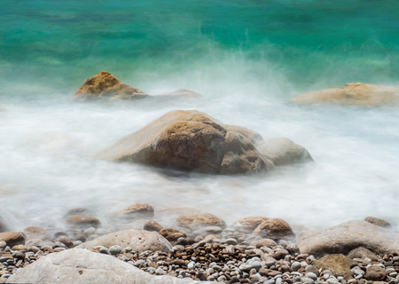 Pictures of marine rocks, taken with long shutter speeds, to fade the waves that surround themの写真素材
