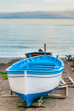 Portrait of a blue and white fishing boat, waiting to cross the seaの写真素材