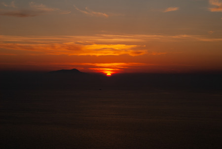 Beautiful sunset on a hot summer day, which has colored the sky and cloudsの写真素材