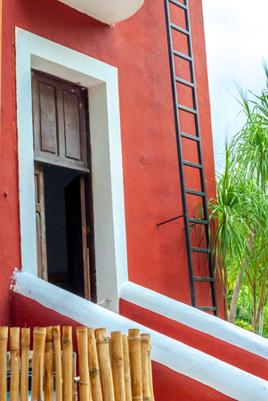 Typical Mexican residential entrance, of a red colored house, taken from Tecoh, in the Yucatan peninsulaの写真素材
