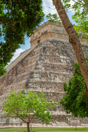 Kukulkan Mayan pyramid, known as El Castillo, classified as 5B18 Structure, taken in the trees, in the archaeological area of Chichen Itza, on the Yucatan peninsulaの写真素材