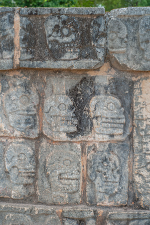 Details of skull engravings, on a Mayan temple, in the archaeological area of Chichen Itza, on the Yucatan peninsulaの写真素材