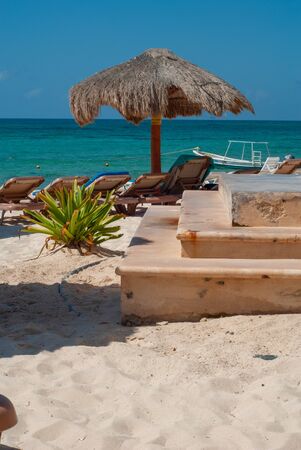 Details of a Tulum beach, with deckchairs and umbrellas, in the Mexican Yucatan peninsulaの写真素材