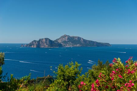Landscape depicting the Capri Island framed by sea and sky, taken on a summer day from Massa Lubrense near Sorrentoの写真素材