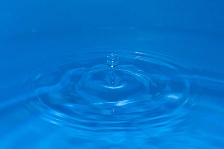 Circular water waves created by a falling drop, with a drop bounce on topの写真素材