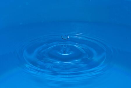 Water sculpture created by a falling drop, with drop of bounce on the topの写真素材