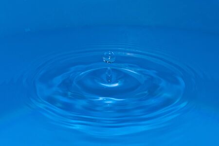 Circular water waves created by a falling drop, with a circular drop bounce on topの写真素材