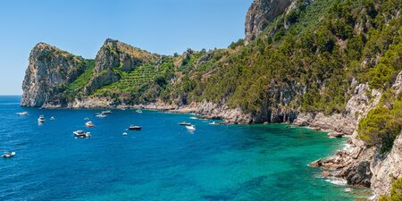 Three mountain laces, which stands on the bay of Nerano of Massa Lubrense, with many boats moored in the watersの写真素材