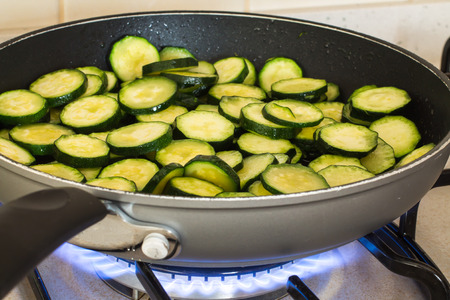 closeup of sliced zucchini while cooking in the panの写真素材