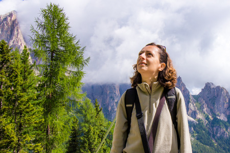 Woman looks the mountain landscape in summer