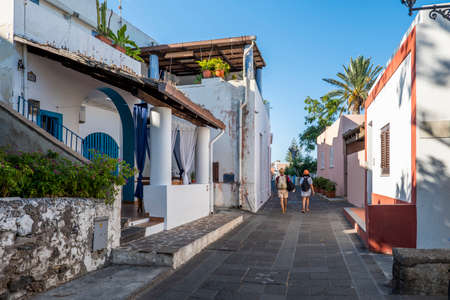The main street of Santa Marina Salina where tourists walk and buy souvenirs, Aeolian Islands, Sicily, Italy.のeditorial素材