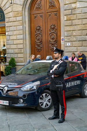 Florence, Italy - March 2, 2019: A police officer of Carabinieri with car on Piazza della Signoria in Florenceのeditorial素材