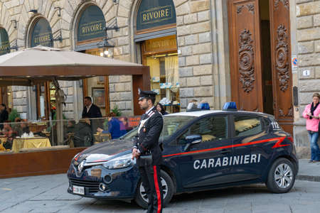 Florence, Italy - March 2, 2019: A police officer of Carabinieri with car on Piazza della Signoria in Florenceのeditorial素材