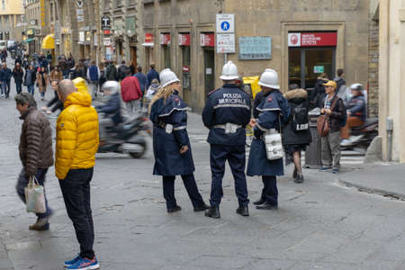 Florence, Italy - March 1, 2019: A police officer talking on the street near Ponte Vecchioのeditorial素材