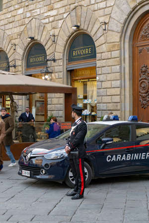 Florence, Italy - March 2, 2019: A police officer of Carabinieri with car on Piazza della Signoria in Florenceのeditorial素材