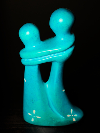 Little blue stone figurine loving embraced couple hugの写真素材