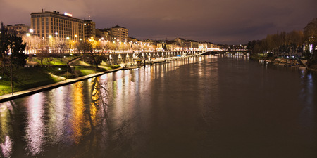 Po river flowing in Turin city along Murazzi docks in a night viewの写真素材