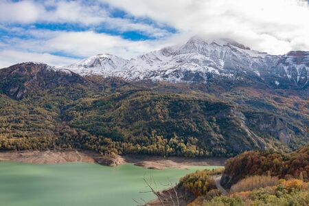 Snowy mountains after a riverの写真素材