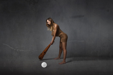 prehistoric first golfer concept, dark backgroundの写真素材