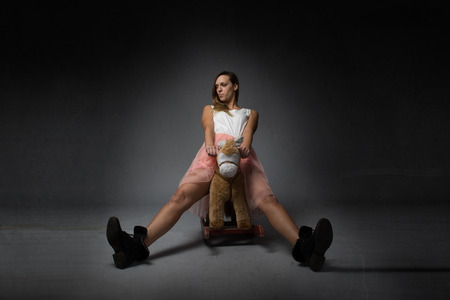 girl riding a rocking horse, open legsの写真素材