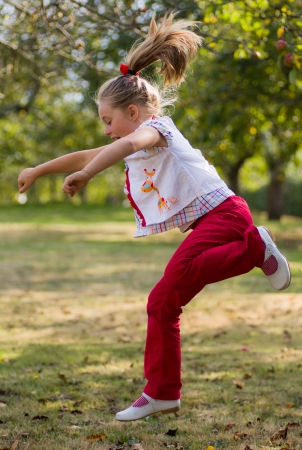 girl jumping in a forestの写真素材
