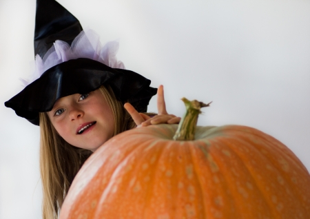 little witch with pumpkin in haloween partyの写真素材