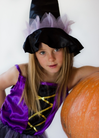 little witch with pumpkin in haloween partyの写真素材