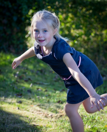 portrait of a blonde little girl in natureの写真素材