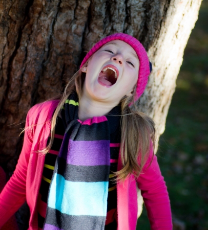portrait of little girl with fall clothes in natureの写真素材