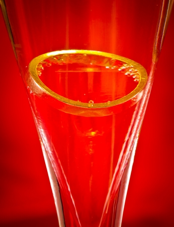 ring in a glass on red backgroundの写真素材