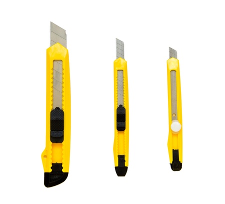 three yellow cutters isolated on whiteの写真素材